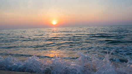 Morning sun and sea waveの写真素材