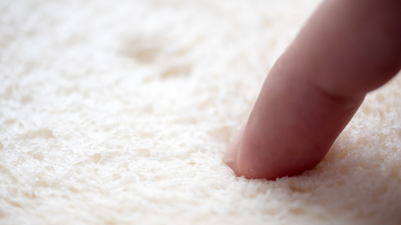 bread and finger hand hold close upの写真素材