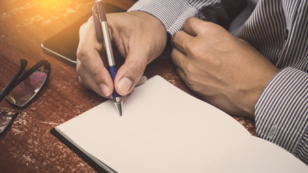 Man hand with pen writing on notebook.の写真素材