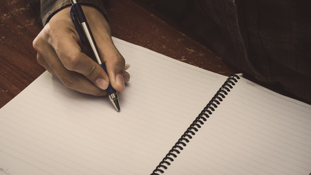 Man hand with pen writing on notebook.の写真素材