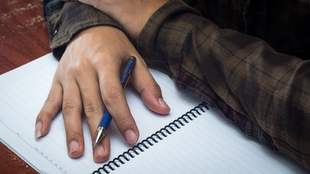 Man hand with pen writing on notebook.の写真素材