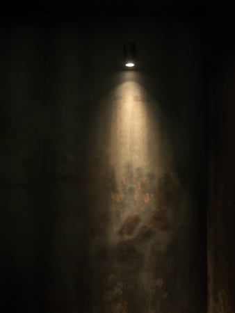 The light on the black rusty wall backgroundの写真素材