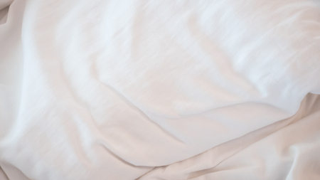 Top view of a messy bedding sheet after night sleep.の写真素材