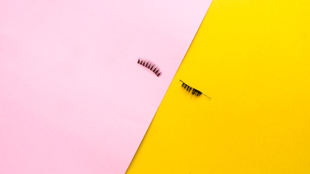 Eyelashes on pink and yellow backgroundの写真素材