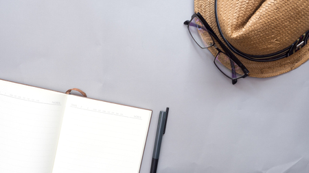 Hat wicker and notebook on gray backgroundの写真素材
