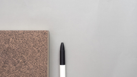 notebook and pen on gray backgroundの写真素材