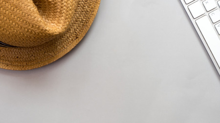 Hat wicker and keyboard on gray background business conceptの写真素材
