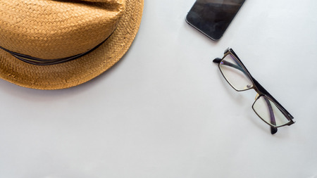 Hat wicker and smartphone with glasses on gray background business conceptの写真素材