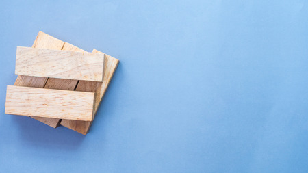 Arranging wood block stacking Business concept on blue backgroundの写真素材