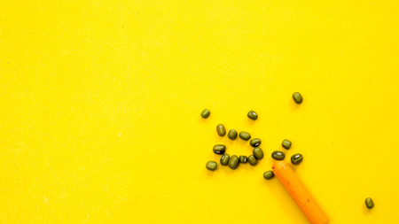 crayon with mung bean on yellow background