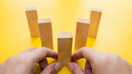 stacking wooden blocks and man hand. Business development conceptの写真素材