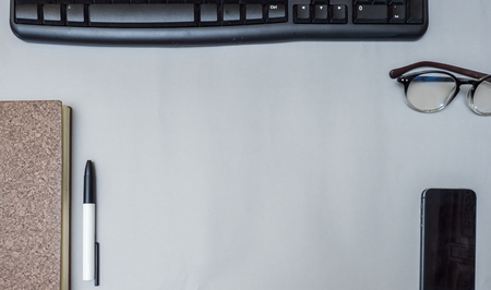 notebook with keyboard and pen on gray background business concept desk tableの写真素材
