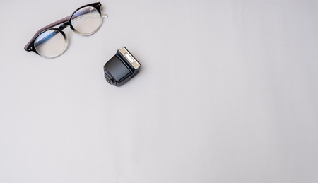 lens with flash camera on gray background business concept desk table