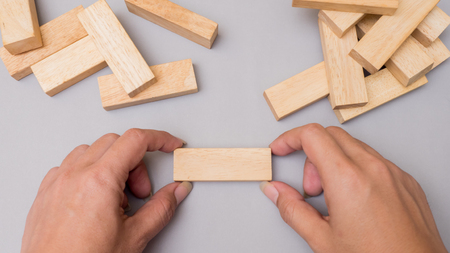 wood block  tower game with hand.Top view copy space