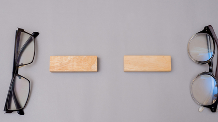 wood block and glasses on gray background copy spaceの写真素材