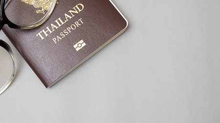 passport and glasses on gray backgroundの写真素材