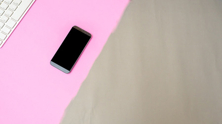 smart phone and keyboard on color paper  flat lay backgroundの写真素材