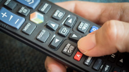 Man press with his finger on remote