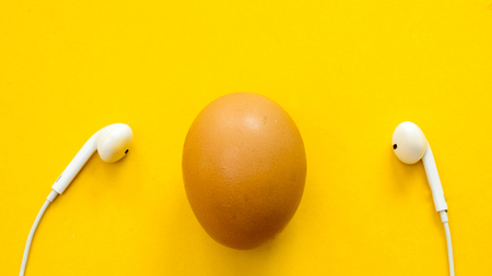 egg and earphone symbol on yellow background