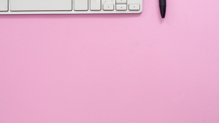 Keyboard of a computer on pink background business conceptの写真素材