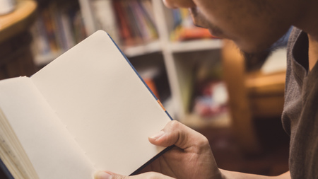Man reading Book in his hands.の写真素材