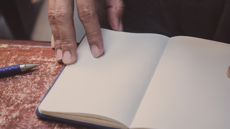 Man press with his finger on notebook close upの写真素材