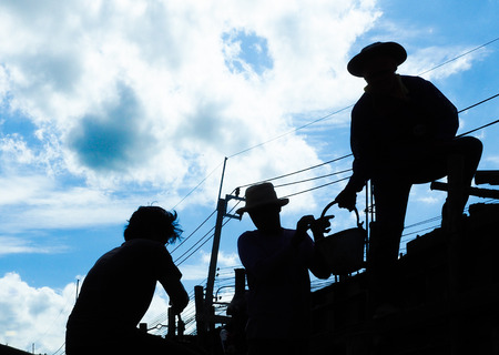 Silhouette workers on background of constructionの写真素材