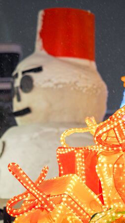 snows man and snow fall with gift close upの写真素材