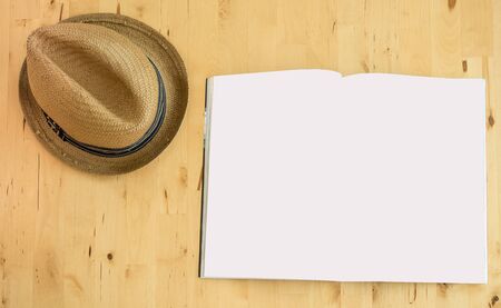 plan your trip concept topview book and hat on wood backgroundの写真素材