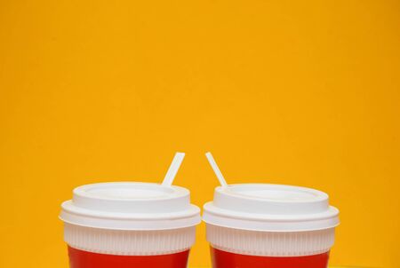Red coffee cup yellow background. Modern conceptの写真素材