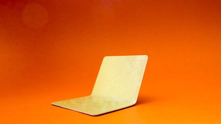 Broken credit card on orange backgroundの写真素材