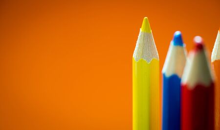 Set of multicoloured  pencil or crayon on orange background. Selective focusの写真素材
