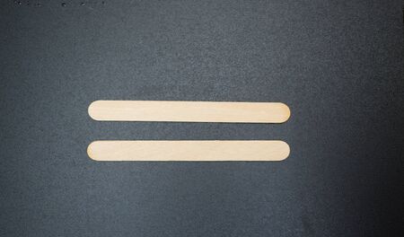 Equal sign on a black backgroundの写真素材
