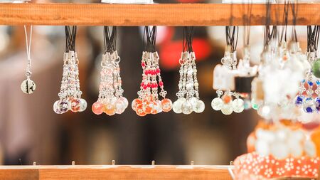 Traditional japan necklaces, handmade souvenirs at marketplace.の写真素材