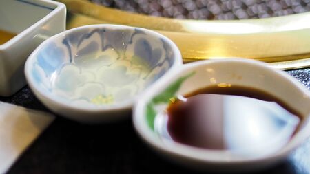 Cup of soy sauce close upの写真素材