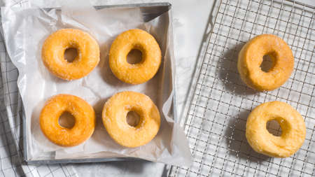 Homemade deep fried donuts in stack with sugar paper marble table.Top viewの写真素材