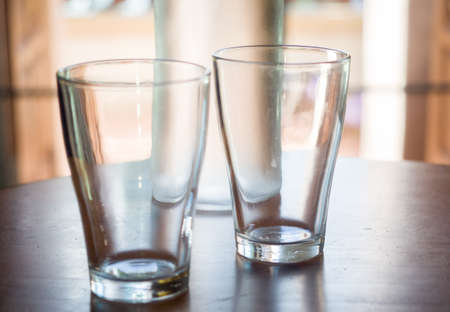 A glass of water on a wooden table close upの写真素材
