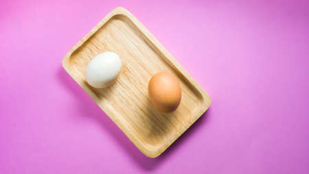 Chicken and duck eggs on a wooden trayの写真素材