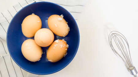 Eggs in a cup on a white background