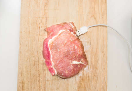 Fresh meat. Raw pork steak with USB on white backgroundの写真素材