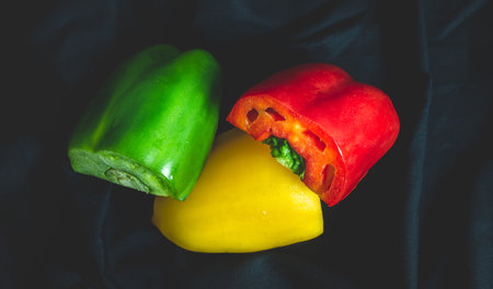 Red, yellow, and green bell peppersの写真素材