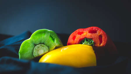 Red, yellow, and green bell peppersの写真素材