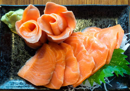 Salmon on black dish top viewの写真素材