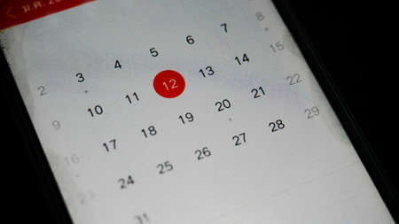 Mobile Calendar in smarth phone with hand close up