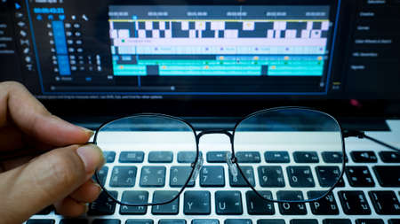 hand holding glasses and computerの写真素材