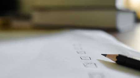 Black marking on checklist box with pencil close up. Checklist concept