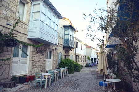 ALACATI, TURKEY - JULY, 11, 2021: Colorful Alacati Houses view in historical Alacati Town. Alacati...