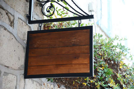 Photo blank signboard on the street. Signboard mockup and template signage frame for and text on the city background.の写真素材