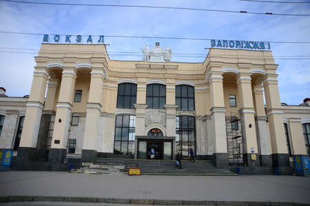 ZAPORIZHIA, UKRAINE - MARCH 24, 2019: Architecture of Zaporizhzhia I train station people waiting with luggage in historic Ukrainian Cityのeditorial素材