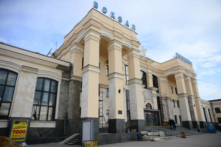 ZAPORIZHIA, UKRAINE - MARCH 24, 2019: Architecture of Zaporizhzhia I train station people waiting with luggage in historic Ukrainian Cityのeditorial素材